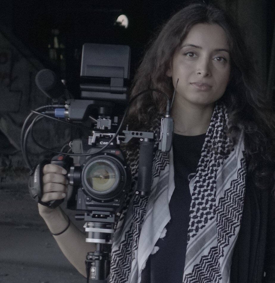 Film maker Deeyha Khan, holding a camera