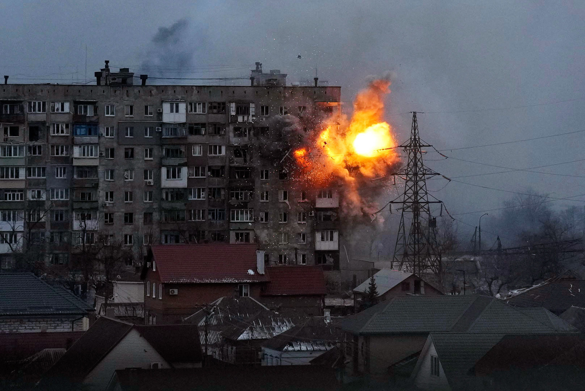 An explosion is seen in an apartment building after Russian's army tank fires in Mariupol, Ukraine, March 11, 2022. Still from FRONTLINE PBS and AP’s feature film “20 Days in Mariupol.” 