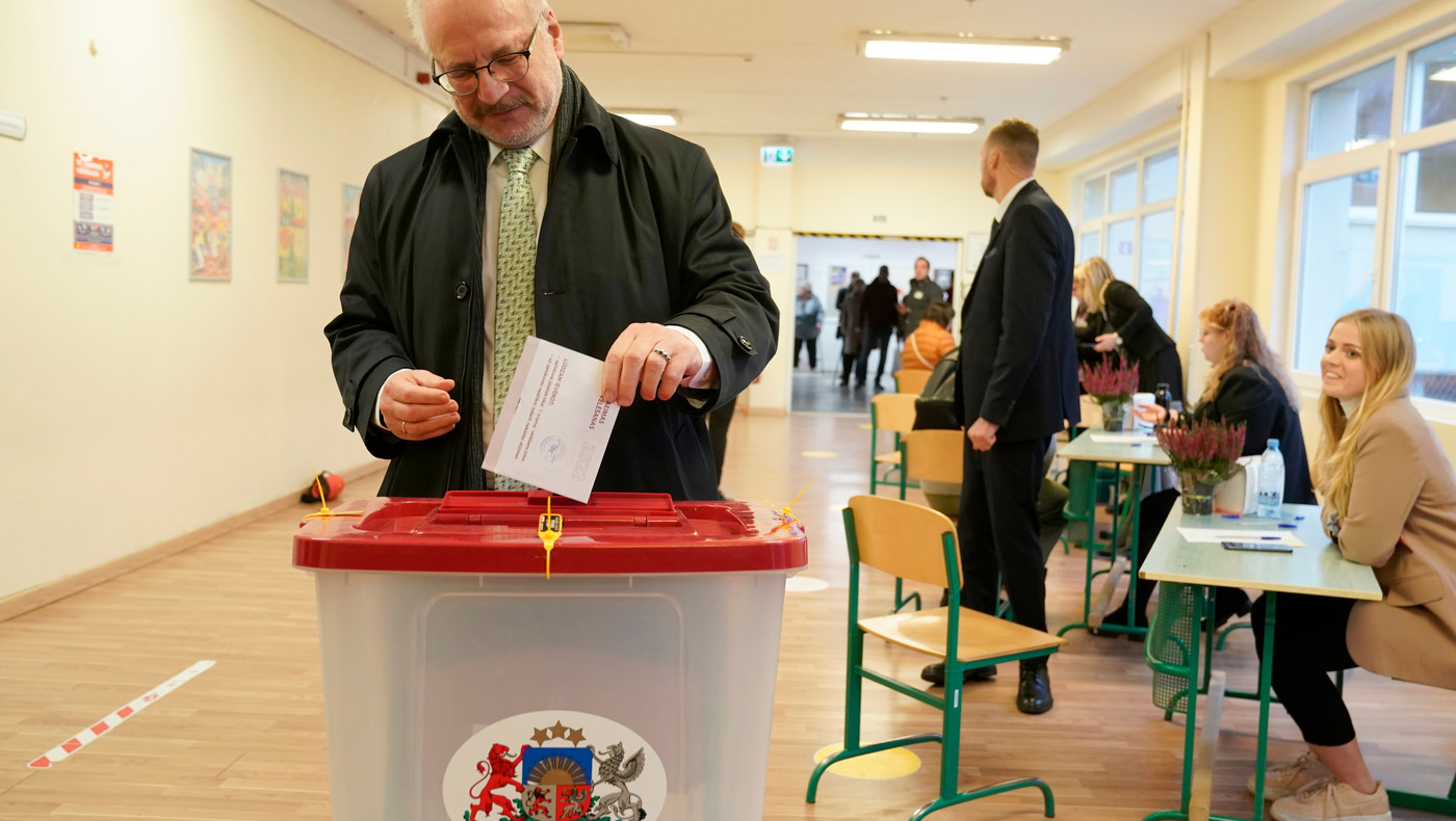 Latvian President Egils Levits ballot at a polling station during general elections in Riga, Latvia, Saturday, Oct. 1, 2022. 