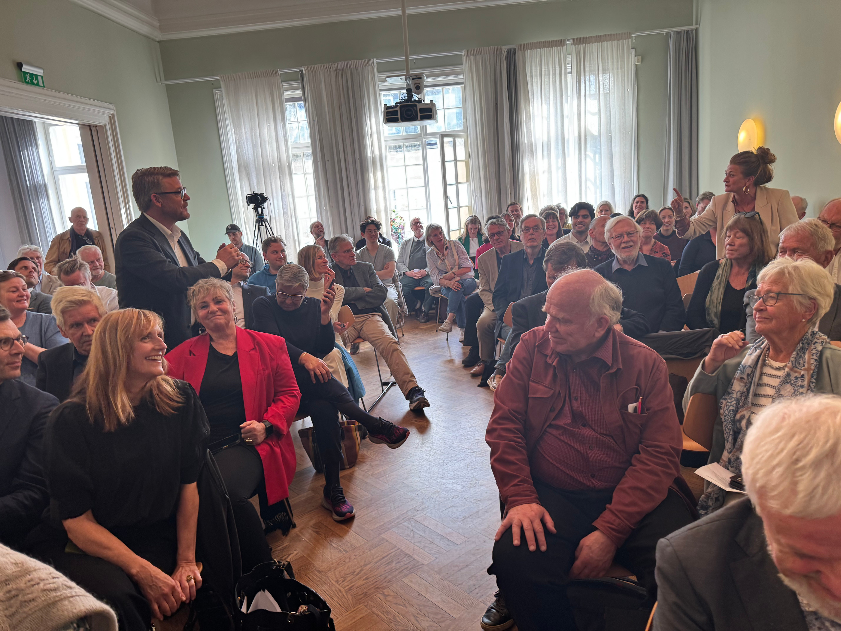 P4s ansvarlige redaktør Kenneth Andresen (stående til venstre) og NRKs radiosjef Cathinka Rodan stiller spørsmål fra salen – og til hverandre. 