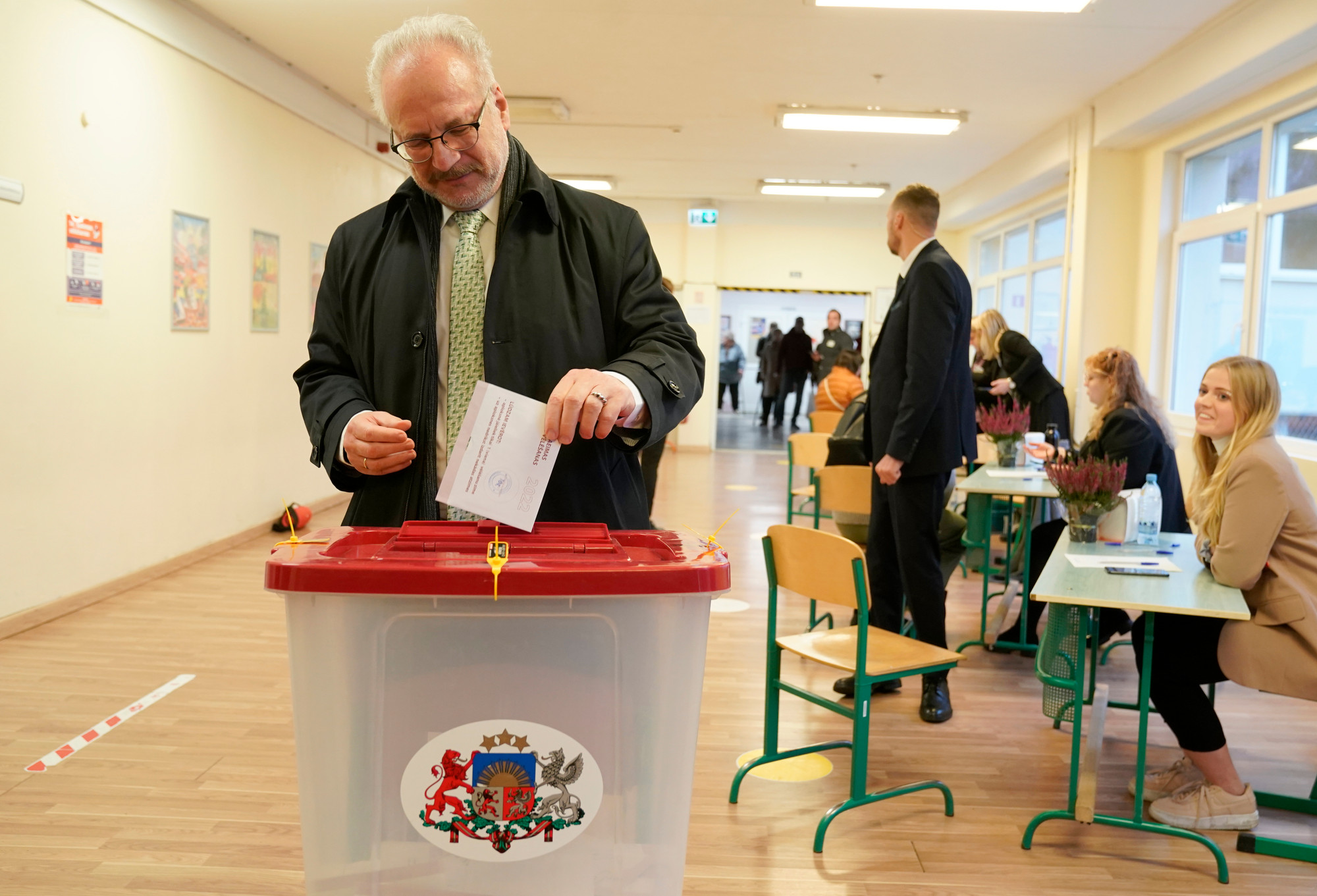 Latvian President Egils Levits ballot at a polling station during general elections in Riga, Latvia, Saturday, Oct. 1, 2022. 